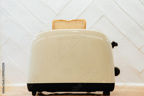 
Close-up of a vintage beige toaster with a slice of bread.
Technology, objects, retro style