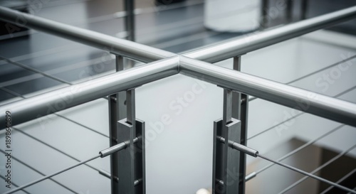 Modern stainless steel railing intersection, geometric pattern, clean lines, industrial interior design