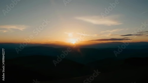 Wallpaper Mural A sunset illuminates rolling hills with golden light; clouds and haze create depth Torontodigital.ca