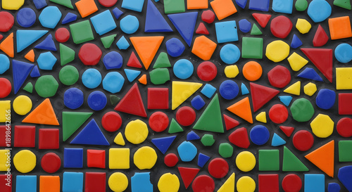 A colorful arrangement of various shaped plastic toys on a dark background