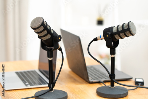 Podcast setup with two microphones and a laptop for an interview in an office environment