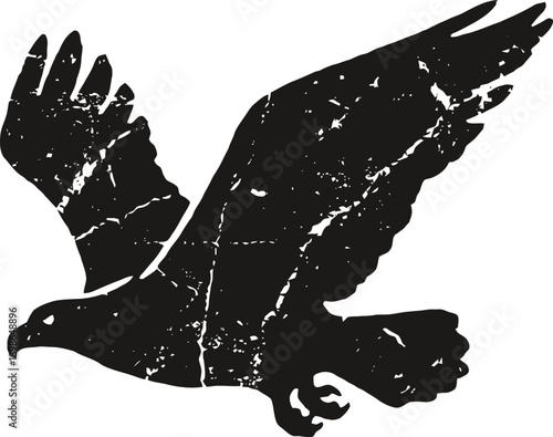 Grunge eagle silhouette in flight with weathered textured wings and sharp beak