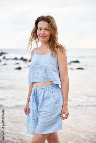 Young girl in blue clothes on the beach