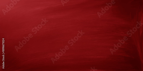 A vintage dark red silk fabric background features a grunge textured material pattern with an aged retro design for a blank wallpaper backdrop