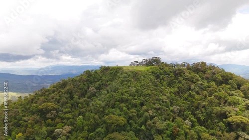 aerial and circular view of a mount with closer look at the top in the middle of the Atlantic Forest in Sao Paulo coast in Brazil