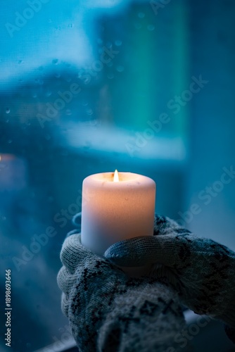 A candle in hand during a power outage in Ukraine