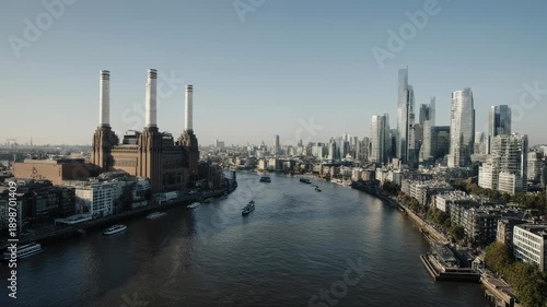 Aerial view of a city with a river flowing through it, showing buildings and smokestacks