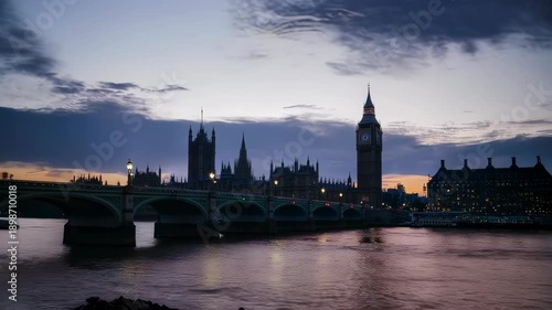 Silhouette of a landmark and bridge over a river, vibrant pink and purple sunset sky
