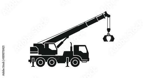 A stark black silhouette depicts a mobile crane with an attached grapple showcasing industrial machinery and power silhouette high quality