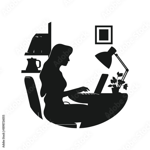 A woman working on her laptop in a home office setting