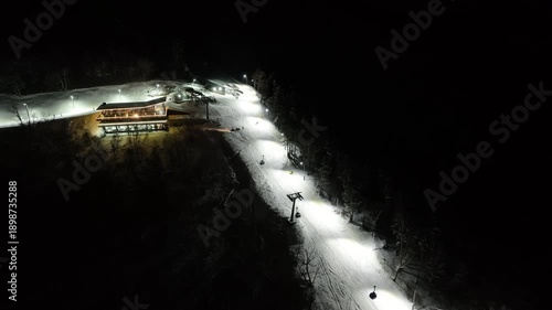 Bakuriani, Georgia - January 3 2026: Aerial view of Skiers and tourists at Cafe near the lift station in Crystal Ski Arena Bakuriani resort