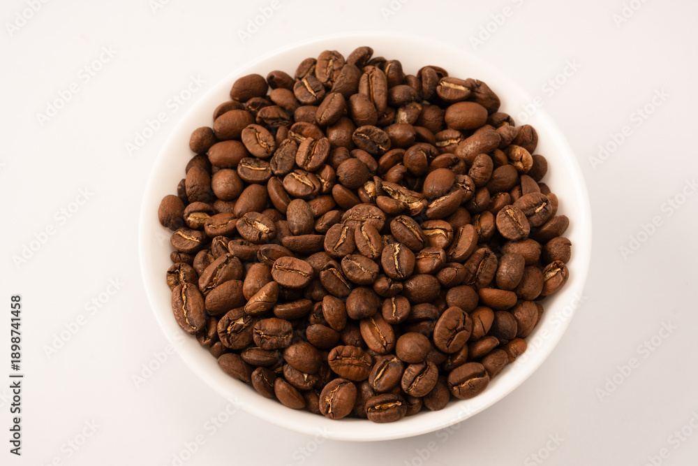 Obraz premium Coffee beans on a white background. Top view. Coffee beans texture.
