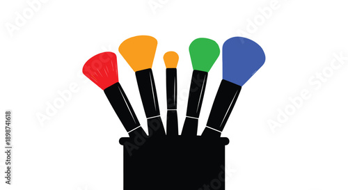 Colorful makeup brushes stand within a black container a studio shot