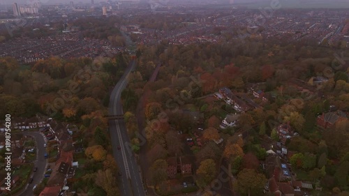 Jesmond Dene during Autumn at dawn. The scene captures dawn light shining through