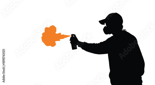 Silhouette of a graffiti artist spraying orange paint with a can