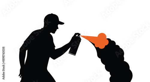 Silhouette of a person spraying orange paint onto a wall