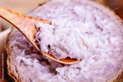 Fresh Purple Taro Root Paste in Wooden Spoon - Traditional Asian Food Ingredient from Guangxi Province