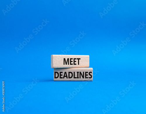 Meet Deadlines symbol. Concept word Meet Deadlines on wooden blocks. Beautiful blue background. Business and Meet Deadlines concept. Copy space