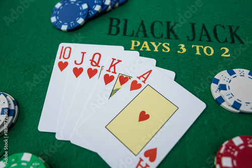 Картината върху платно Winning poker straight combination with playing cards and chips on green table