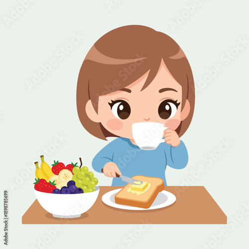 Cute child with brown hair spreading butter on toast and drinking from white cup at wooden table with bowl of fresh fruit