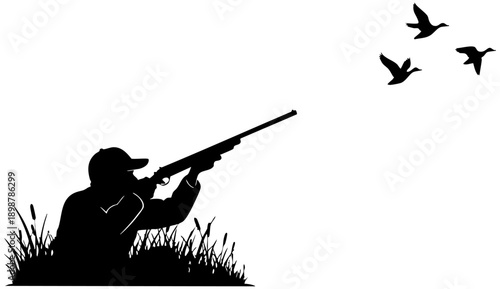 Silhouette of a hunter crouching low in tall grass aiming a long rifle toward flying waterfowl birds
