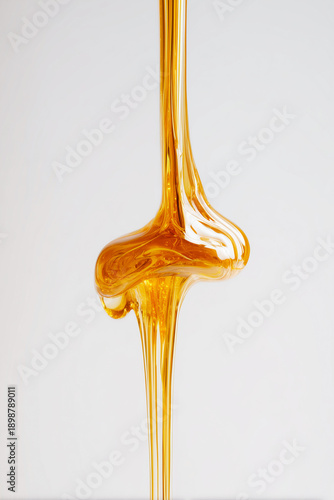 Caramel/honey drips in a long stream (close-up, macro food)