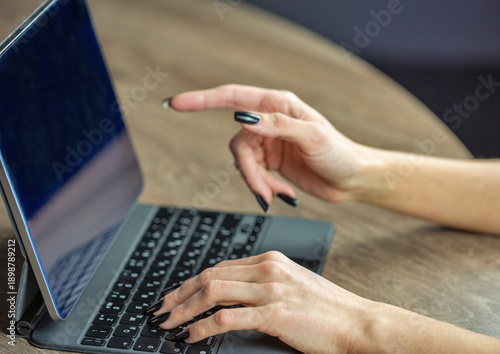 Woman hands working on tablet with wireless keyboard setup