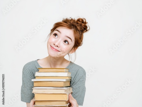 Woman holding a stack of books, happy expression, white background on white background