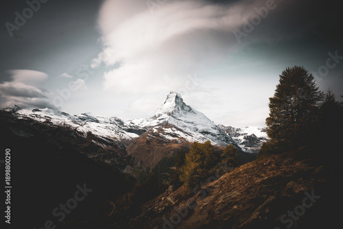 Obraz na płótnie The iconic Matterhorn mountain peak covered in snow under a dramatic cloudy sky in Zermatt, Switzerland