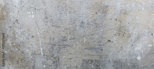 Scratched Gray Concrete Surface Texture with Random Marks. Gray concrete surface filled with scratches and random marks, creating a raw industrial abstract background