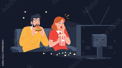 Surprised couple sitting on a sofa in a dark room watching television while eating popcorn and a burger for dinner.