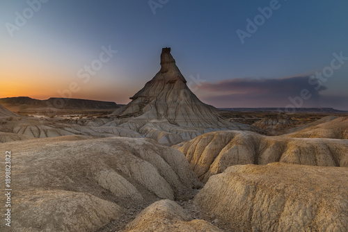 Dramatic evening light over the iconic Castildetierra formation, Bardenas Blanca, Spain.