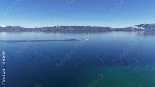 Jet Skis across glassy Lake Tahoe in Winter