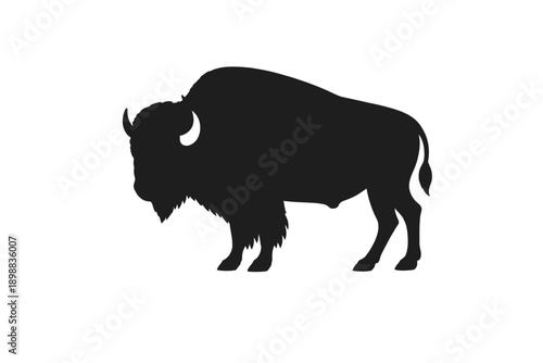 Silhouette of a majestic bison standing in profile against a plain background