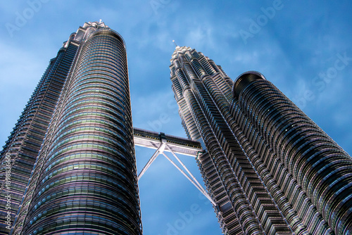 Bild auf Leinwand Skyscrapers captured at dusk from a low angle – illuminated modern skyscrapers w