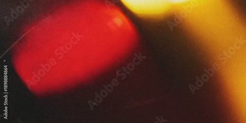 Bild auf Leinwand Abstract blurred image featuring a large vibrant red shape with golden light fla