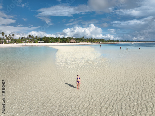 Woman in bikini stands on a...