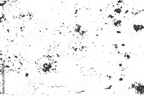 Scattered dark gray irregular shapes and dots on white