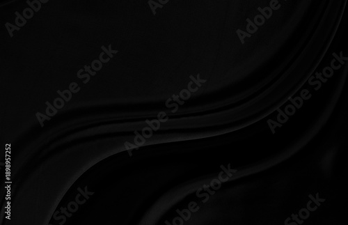Black gray satin dark fabric texture luxurious shiny that is abstract silk cloth background with patterns soft waves blur beautiful.