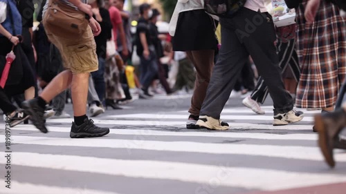 Low Angle View of World's Busiest Crosswalk At Dusk Focus On Feet
