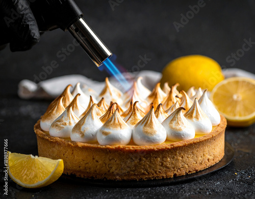 Obraz na płótnie Hand with torch caramelizing meringue