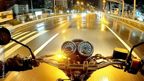 Motorcycle POV night ride on wet city street, illuminated by streetlights and vehicle lights.