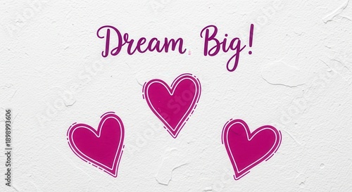 Inspirational 'Dream Big' Quote Surrounded by Decorative Magenta Hearts on Textured White Background