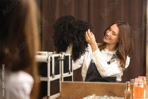 Female hairdresser with cur...
