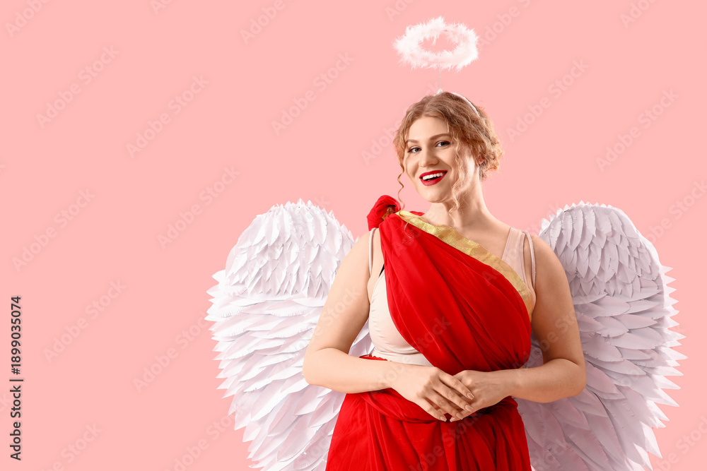 Fototapeta premium Beautiful woman dressed as Cupid on pink background. Valentine's Day celebration