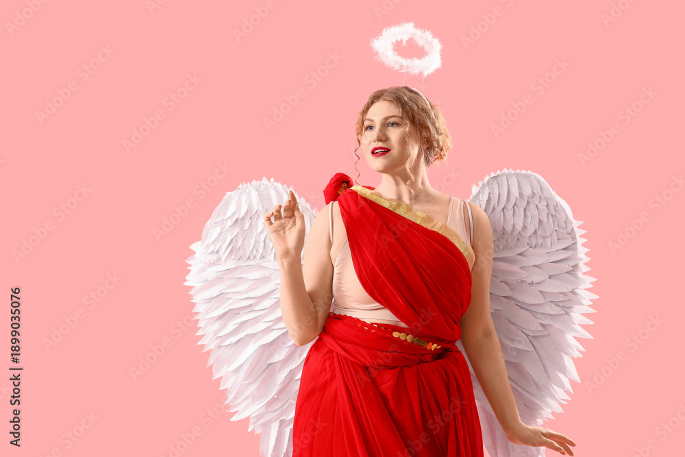 Fototapeta premium Beautiful woman dressed as Cupid on pink background. Valentine's Day celebration