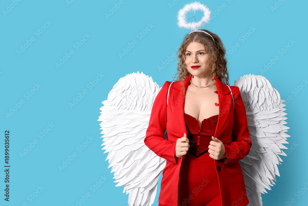 Fototapeta premium Beautiful woman dressed as Cupid on blue background. Valentine's Day celebration