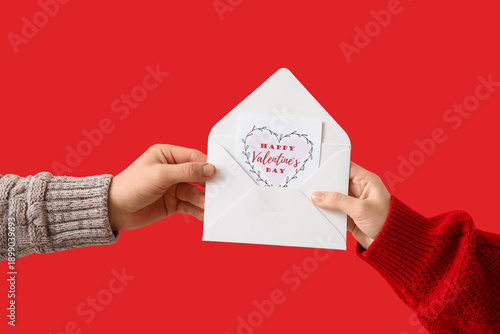 Hands of couple with envelo...