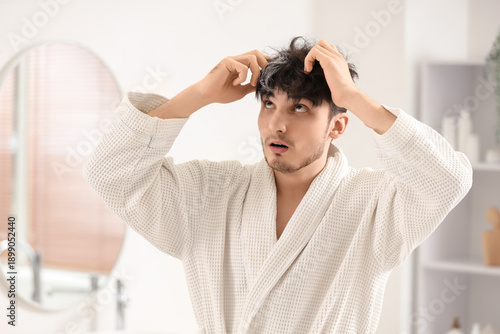 Worried young man with gray...