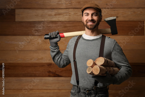 Man with ax and firewood on...